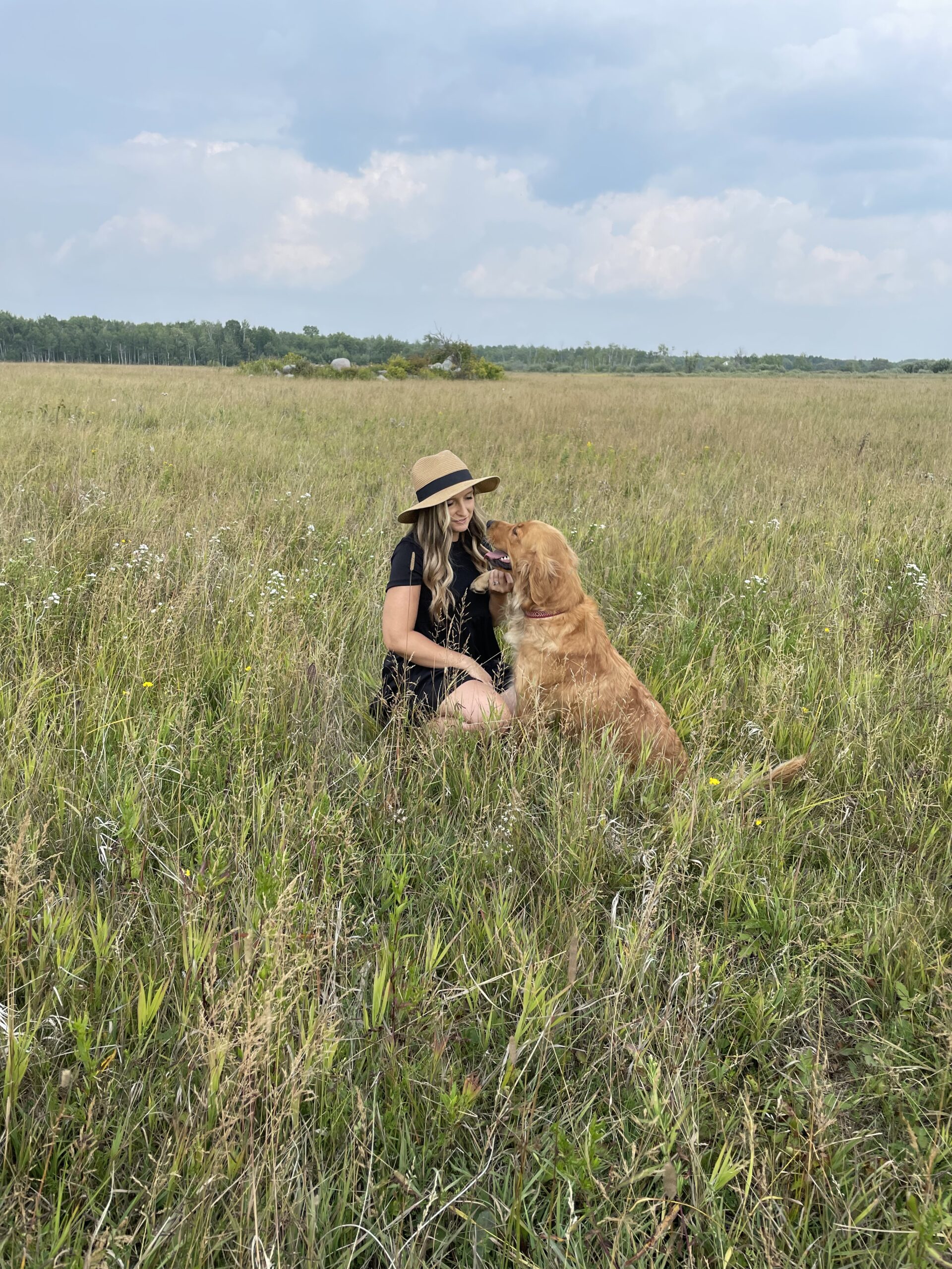Mother behind Lady Slipper Homestead with dog in field
